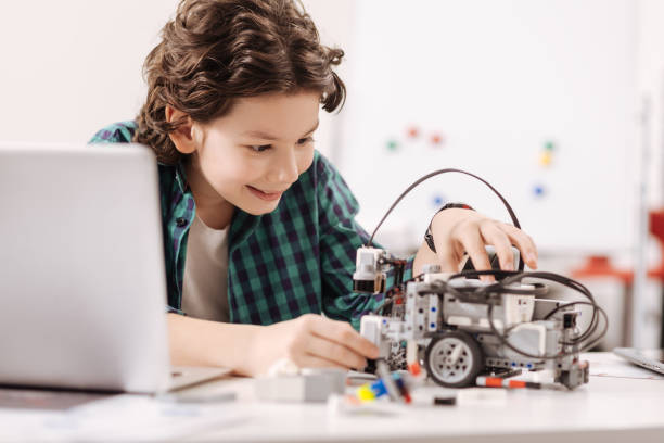 istock Charming teen boy studying in the science studio 653948680