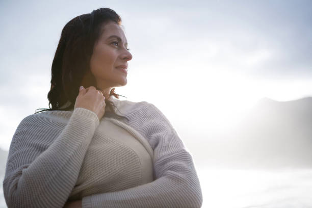 istock Thoughtful woman in sweater on beach 653950178