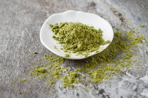 istock Matcha tea on a small white plate. Gray background. 653950682