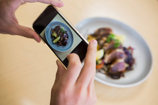 istock Man taking photograph of meal 653951164