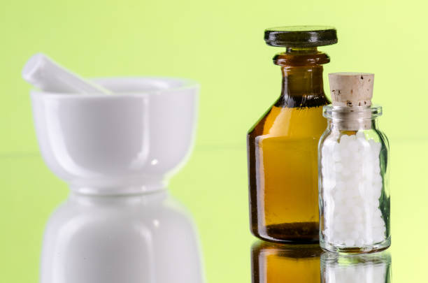 istock homeopathic pills with glass bottle and mortar 653952108