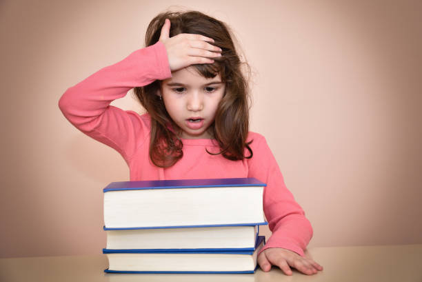 istock Surprised young girl and books 653954492