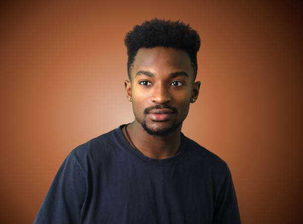 istock young african man portrait brown gradient background 653954974