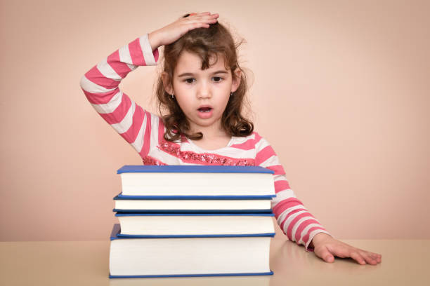 istock Surprised young girl and books 653955310