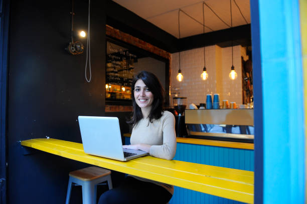 istock Young woman working in a coffee shop 653958368