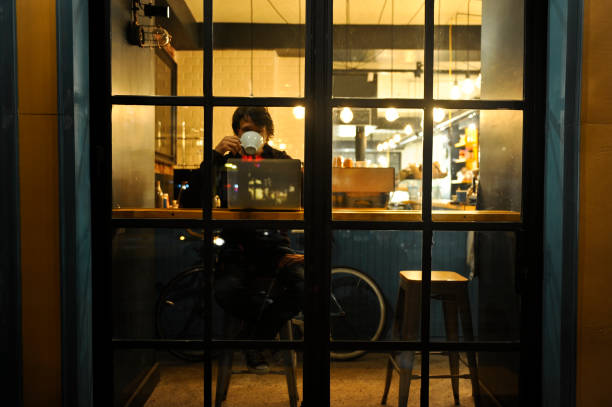 Young man working late in a coffee shop