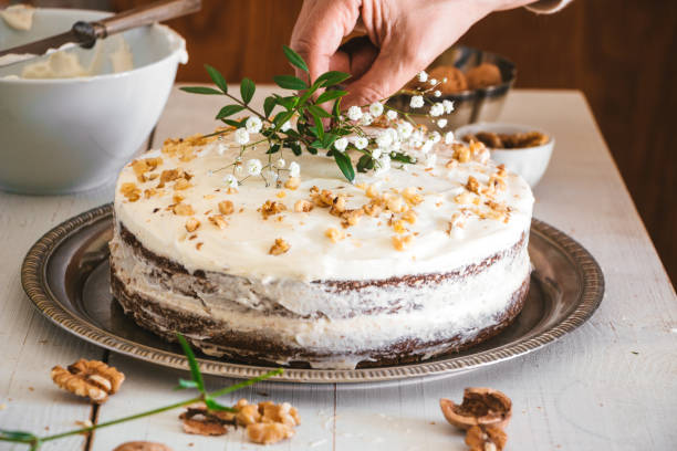 istock Decorating carrot cake with flowers 653959734
