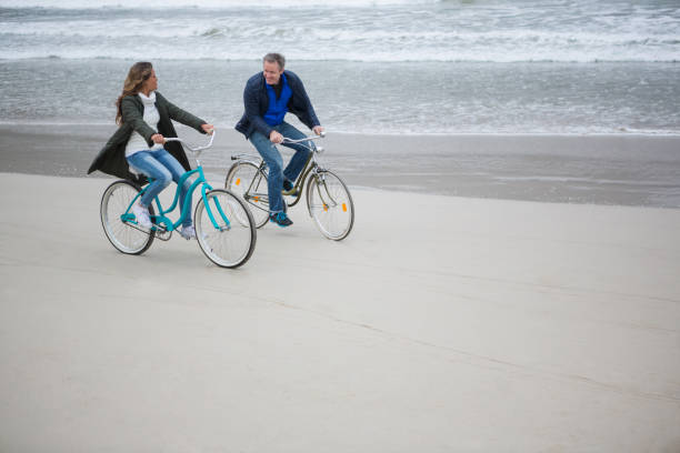 istock Couple riding bicycle on beach 653961616
