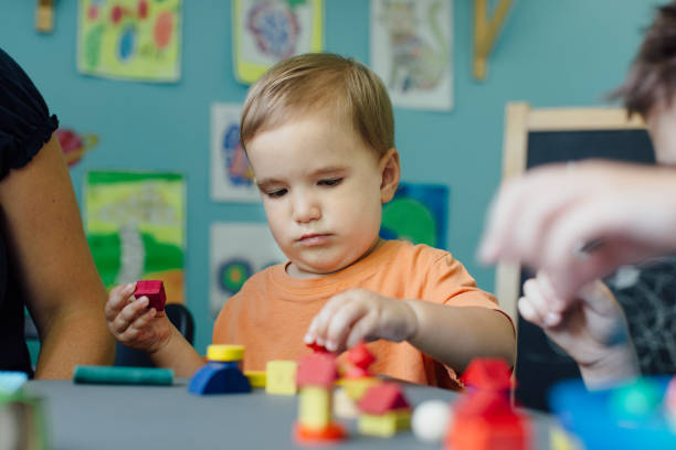 istock Focused toddler playing with blocks and learning shapes 653962948