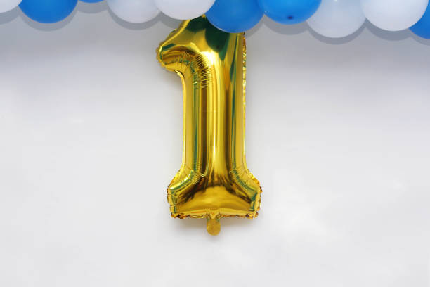 istock First birthday, anniversary decoration on white wall 653964212