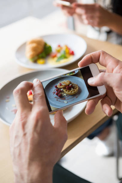 istock Couple taking a photo of their snacks 653964838