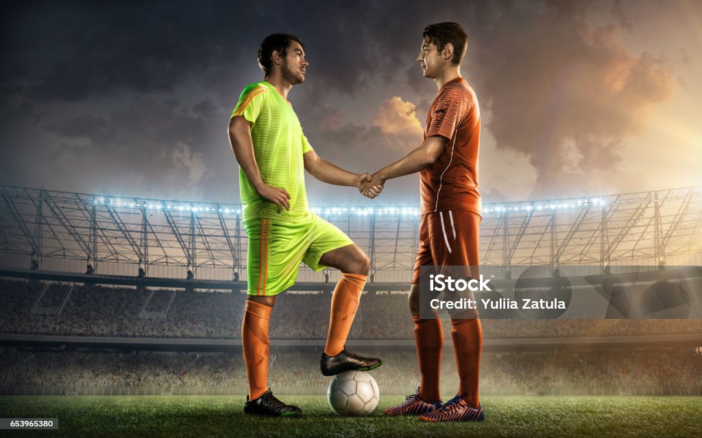soccer team captains shaking hands two soccer team captains on a soccer field shaking hands before the game Soccer Player Stock Photo