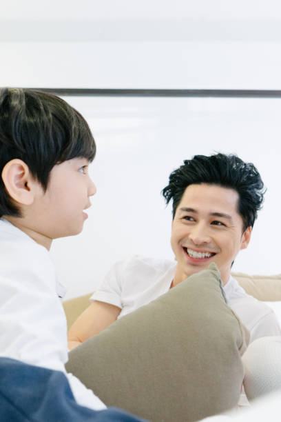 istock Father playing with baby son on bed 653966926