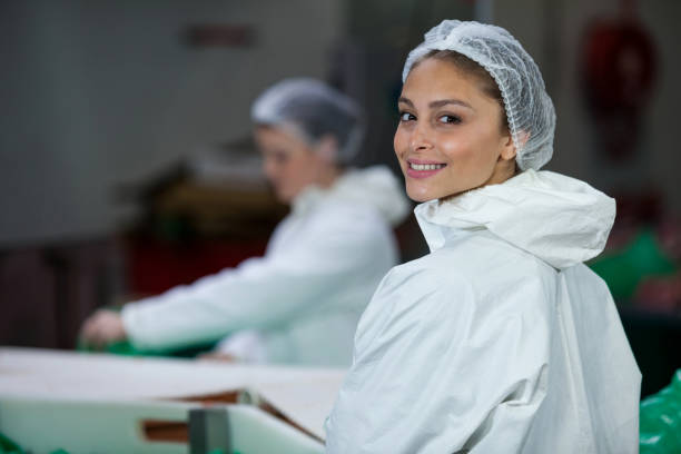 istock Smiling butcher standing in meat factory 653967064