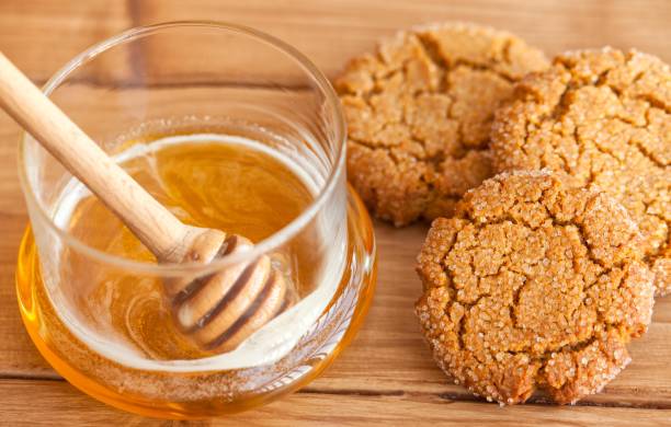 Honey ginger cookies with milk on a black background, selective focus stock photo