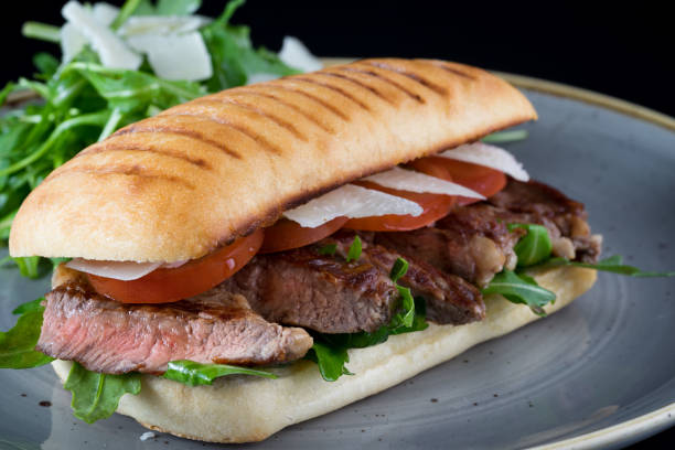 istock grilled steak sliced sandwich with salad 653968714
