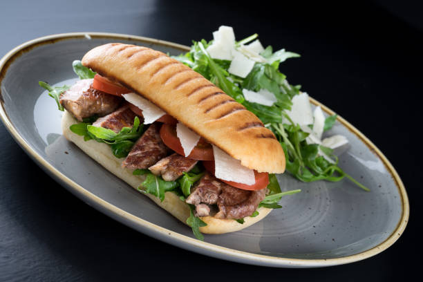 istock grilled steak sliced sandwich with salad 653969188