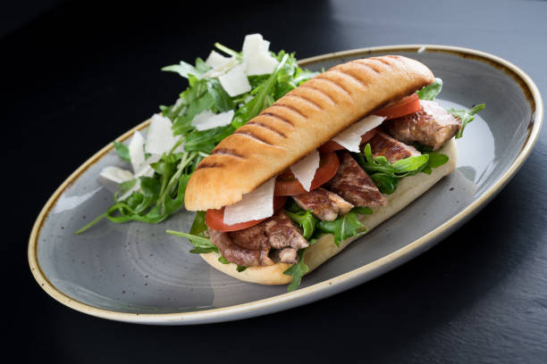 istock grilled steak sliced sandwich with salad 653969278