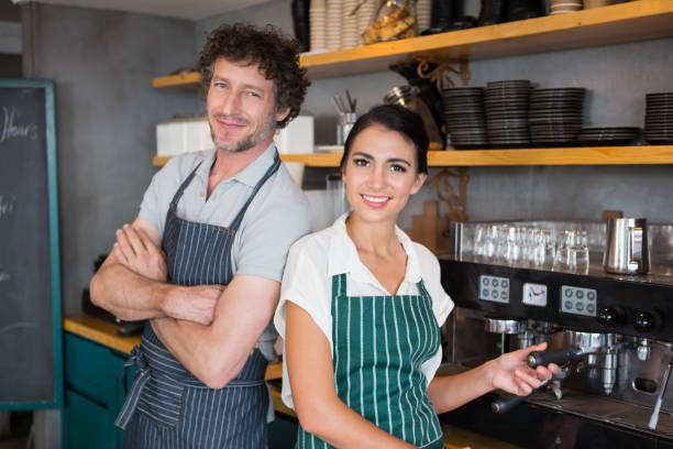 istock Waiter and waitress in cafeteria 653970016