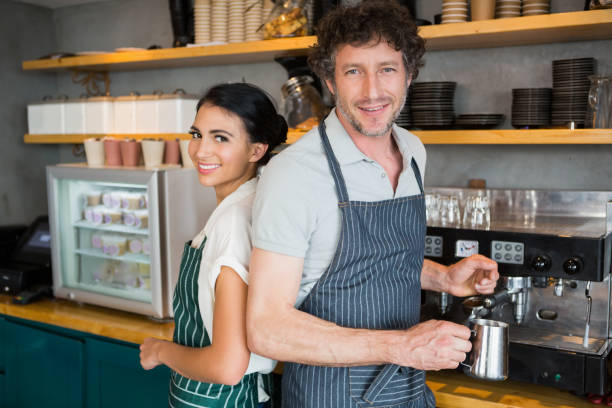 istock Waiter and waitress in cafeteria 653970032