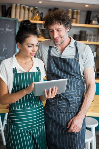 istock Waiter and waitress discussing over digital tablet 653970148