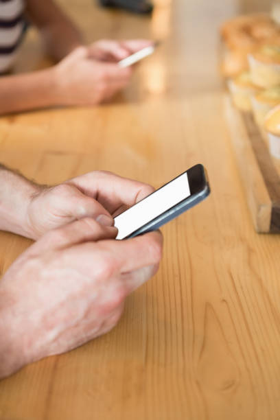 istock Close-up of man text messaging on mobile phone 653970434