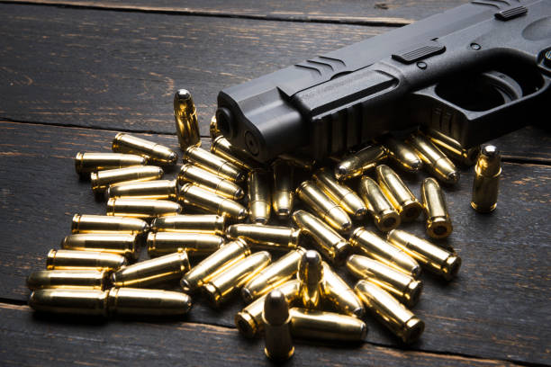 istock Bullets and Gun on wood background 653970618