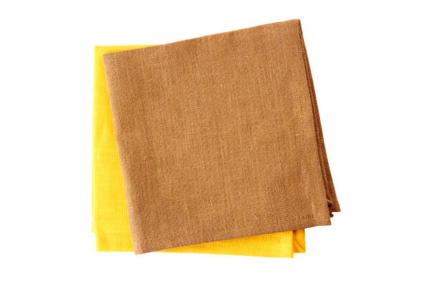 istock Two colorful napkins, yellow and brown, on white 653972184