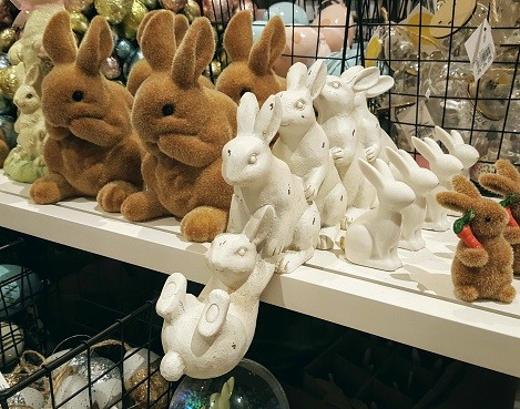 A variety of wooden rabbits and Easter decorations for sale.