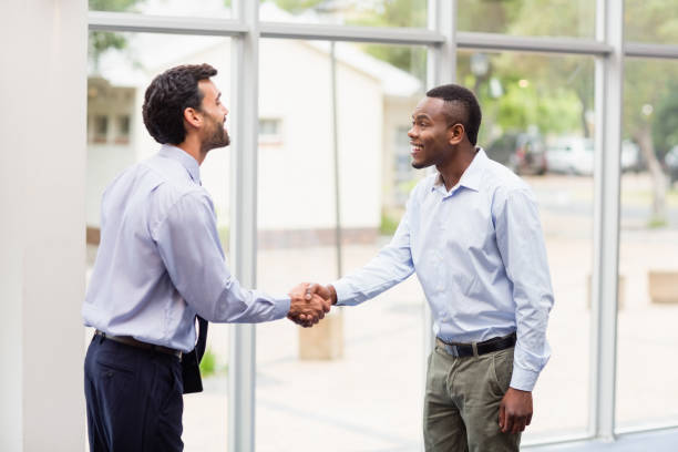 istock Business executives shaking hands with each other 653974382