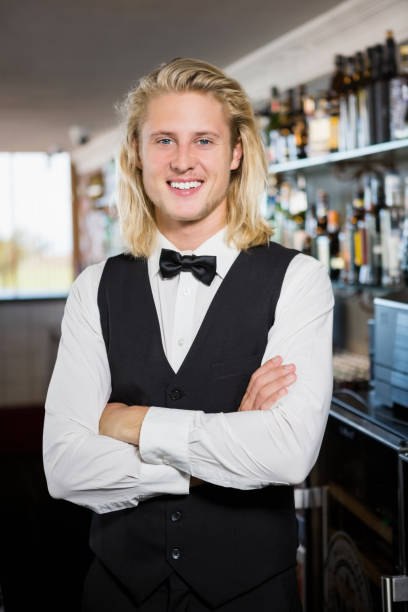 istock Waiter with arms crossed standing in restaurant 653975012