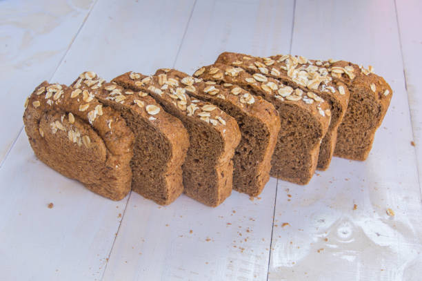 istock Fresh whole grain bread on white wood background 653975338