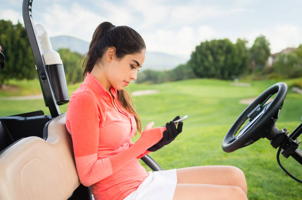 young hispanic women playing golf - golf course golf people sitting imagens e fotografias de stock