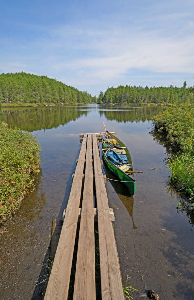 Canoe Dock in the Wilds Canoe Dock in the Wilds on Swamp Lake in Quetico Provincial Park in Ontario boundary waters canoe area stock pictures, royalty-free photos & images