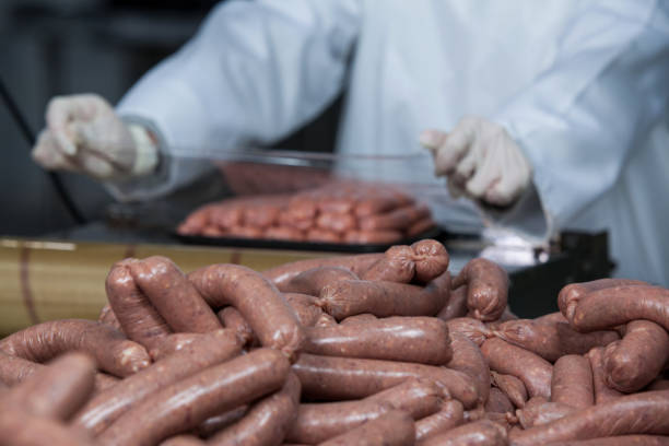 istock Butcher packing raw sausages 653979408