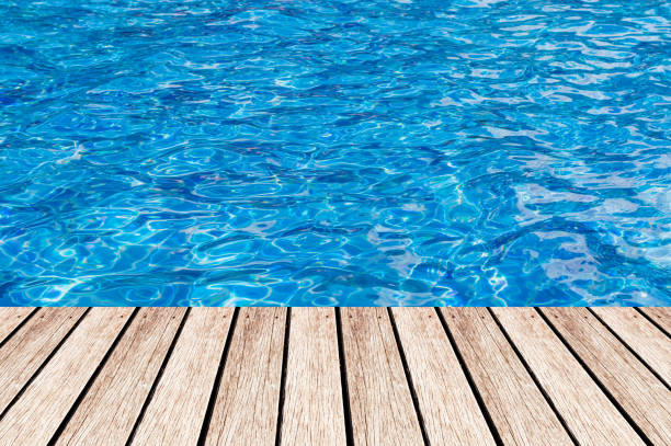 istock Wood table top on Surface water in pool background - can be used for display or montage your products 653985228