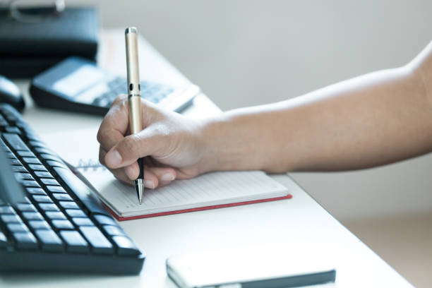 istock Focus of hand modern women take notes on table 653985244