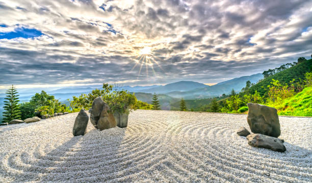 Rock Garden with the rays of sunshine radiating in the sky creates a peaceful feeling Bao Loc, Vietnam - February 17th, 2017: Rock Garden with the rays of sunshine radiating in the sky creates a peaceful feeling at Bao Loc, Vietnam. japanese rock garden stock pictures, royalty-free photos & images