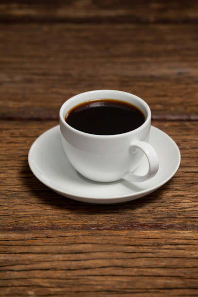 istock Cup of coffee on wooden table 653988868
