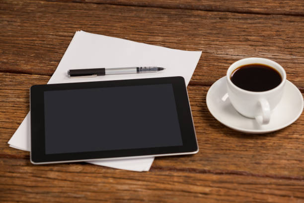 istock Digital tablet and cup of coffee 653990612