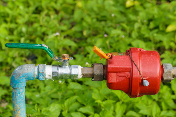 Water pipes with meter and shutoff valve stock photo