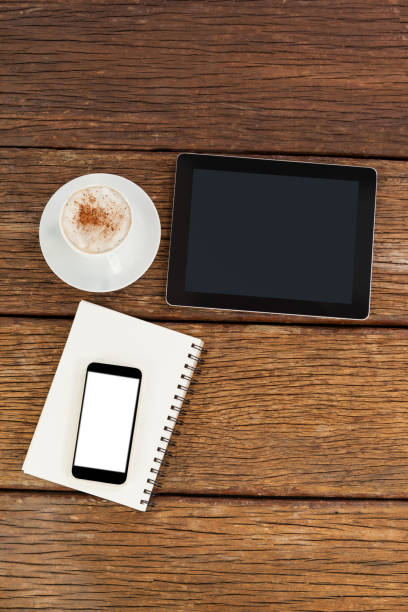 istock Digital tablet with smartphone and cup of coffee 653990870