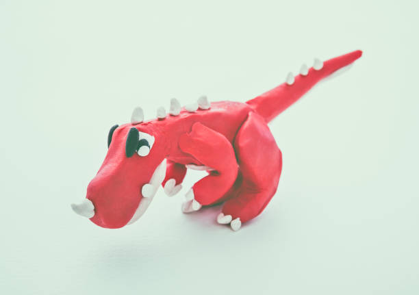 istock Red dinosaur clay model. Play dough animal. Vintage tone effect. 653994056