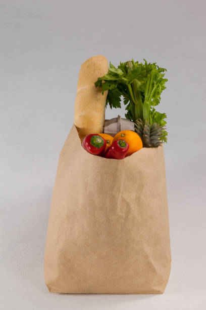 istock Fruits and vegetables in brown grocery bag 653997356