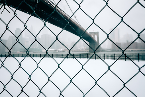 The Brooklyn Bridge, shot through a chainlink fence during Winter Storm/Blizzard Stella