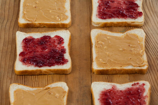 istock Peanut butter and jam on bread slices 653997456