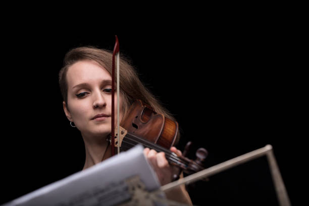 istock violinist reading music score and playing 653997694