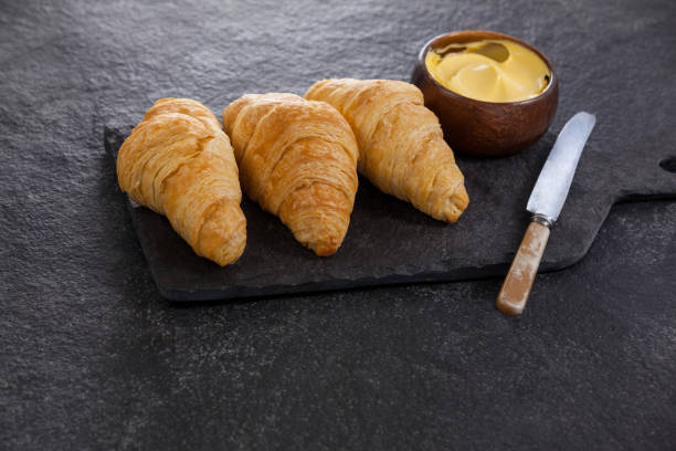 istock Croissants with butter and knife 653997736
