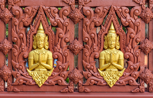 Row of Buddha statues on Buddhist temple wall, Generally in Thailand, any kinds of art decorated in Buddhist church, temple , chapel, pavilion, temple hall, monk’s  house etc. created with money donated by people to hire artist. They are public domain or treasure of Buddhism, no restrict in copy or use, no name of artist appear (but, if there is artist name, it only for tell who is the artist of work, not for copyright). This photo is taken under these conditions.