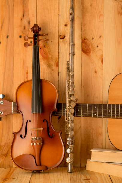 istock violin,guitar and flute on wood. background,still life 654000840